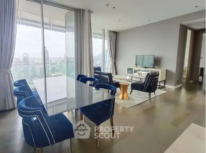 Luxurious high-rise living room with stunning city view and elegant blue dining chairs.