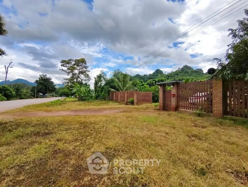 Scenic land plot with lush greenery and mountain views, perfect for development or investment.
