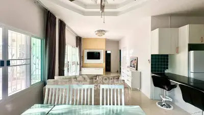 Spacious living room with modern decor and open kitchen layout