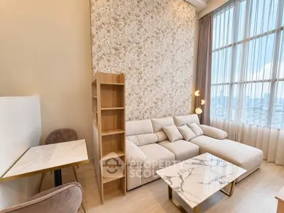 Luxurious living room with elegant marble tables and plush sofa, featuring floor-to-ceiling windows and stylish decor.
