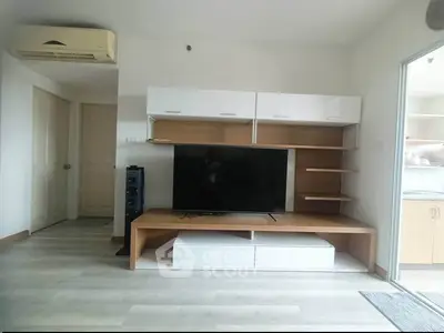 Modern living room with sleek TV unit and air conditioning, showcasing contemporary design and comfort.