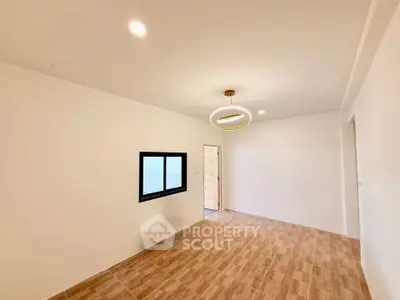 Spacious minimalist room with modern lighting and wooden flooring