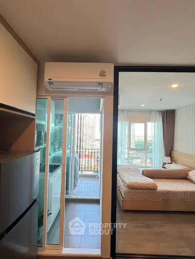 Modern apartment interior with kitchen, bedroom, and balcony view