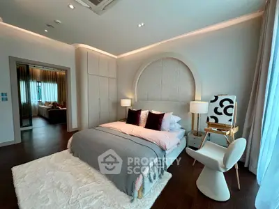 Luxurious modern bedroom with elegant decor and cozy ambiance, featuring stylish furniture and soft lighting.