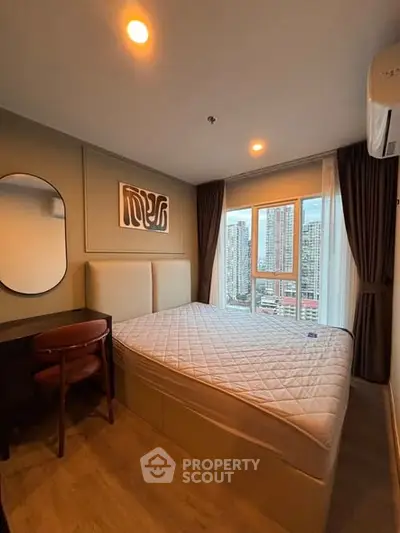 Modern bedroom with city view, featuring stylish decor and ample natural light.