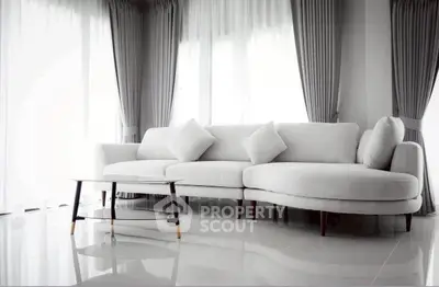Elegant living room with modern white sofa and chic curtains, perfect for stylish urban living.