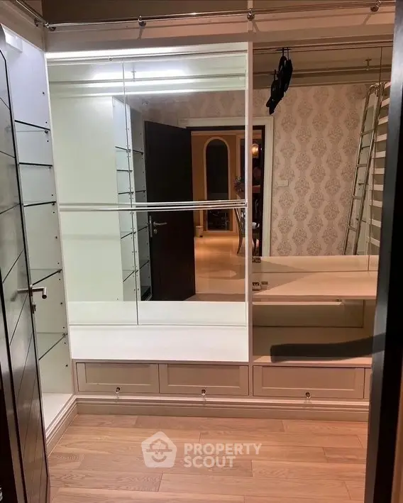 Spacious walk-in closet with elegant shelving and ample storage space.