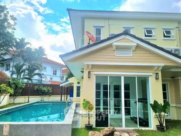 Stunning two-story home with private pool and lush garden, perfect for luxurious living.