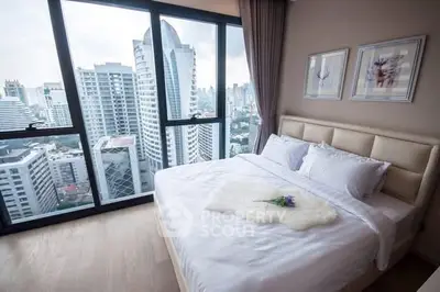 Luxurious bedroom with stunning city view from floor-to-ceiling windows in modern high-rise apartment.