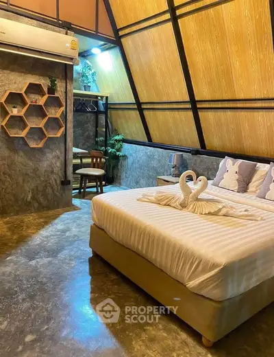 Chic bedroom with modern decor and unique ceiling design, perfect for cozy living.