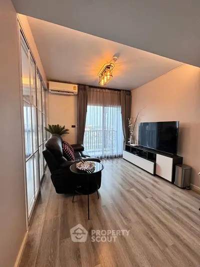 Modern living room with sleek flooring and large TV setup