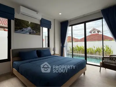 Spacious bedroom with pool view and modern decor in a luxury home