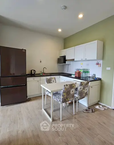 Charming kitchen with modern appliances and cozy dining area, perfect for culinary enthusiasts.