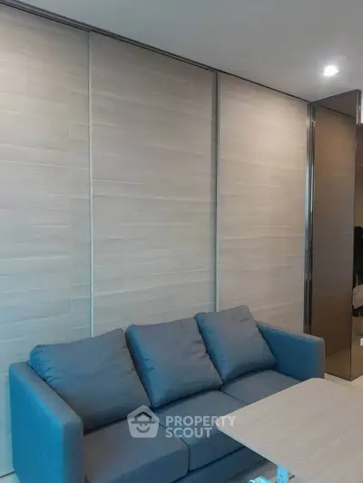 Modern living room with sleek gray sofa and stylish wooden paneling