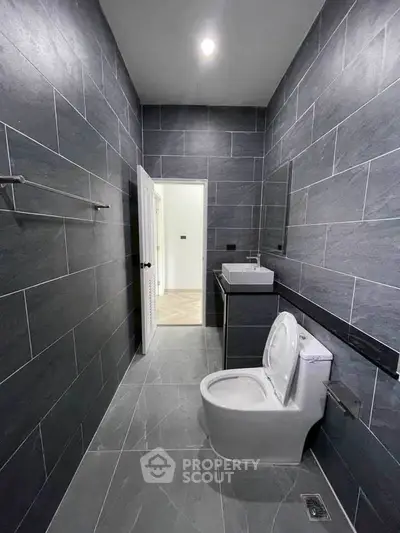 Modern bathroom with sleek gray tiles and contemporary fixtures