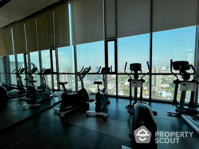 Modern gym with panoramic city view and exercise equipment