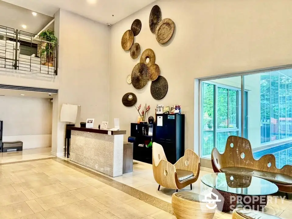 Modern lobby with artistic decor and glass walls in luxury building