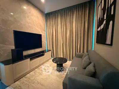 Luxurious living room with modern decor, featuring a sleek TV setup and elegant furnishings.