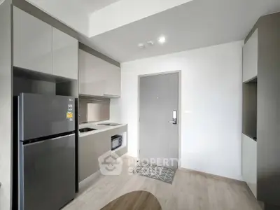 Modern kitchen with sleek cabinetry and stainless steel appliances in a stylish apartment.