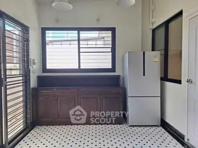 Spacious kitchen with modern fridge and ample storage cabinets