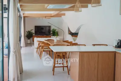 Spacious modern living room with open kitchen, wooden accents, and stylish decor.