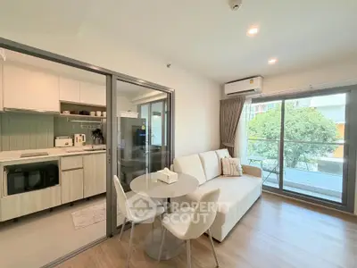 Modern living room with open kitchen and balcony view in stylish apartment