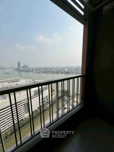 Stunning high-rise balcony view overlooking cityscape and river, perfect for urban living.