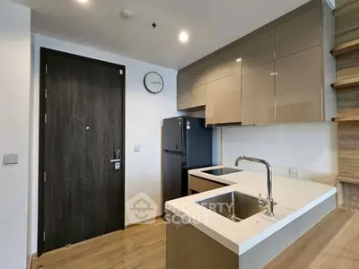 Modern kitchen with sleek cabinetry and built-in appliances in a stylish apartment.