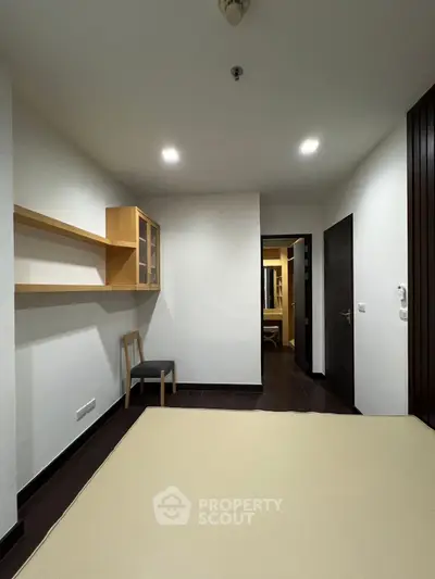 Modern minimalist bedroom with sleek wooden accents and ample lighting