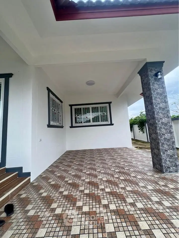 Spacious tiled entrance with modern design and covered area