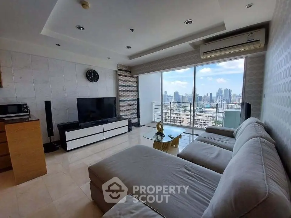 Spacious living room with panoramic city view and modern furnishings