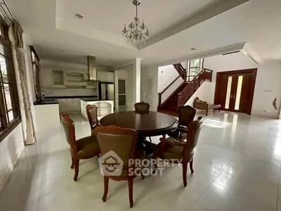 Spacious open-plan living area with elegant dining set and modern kitchen