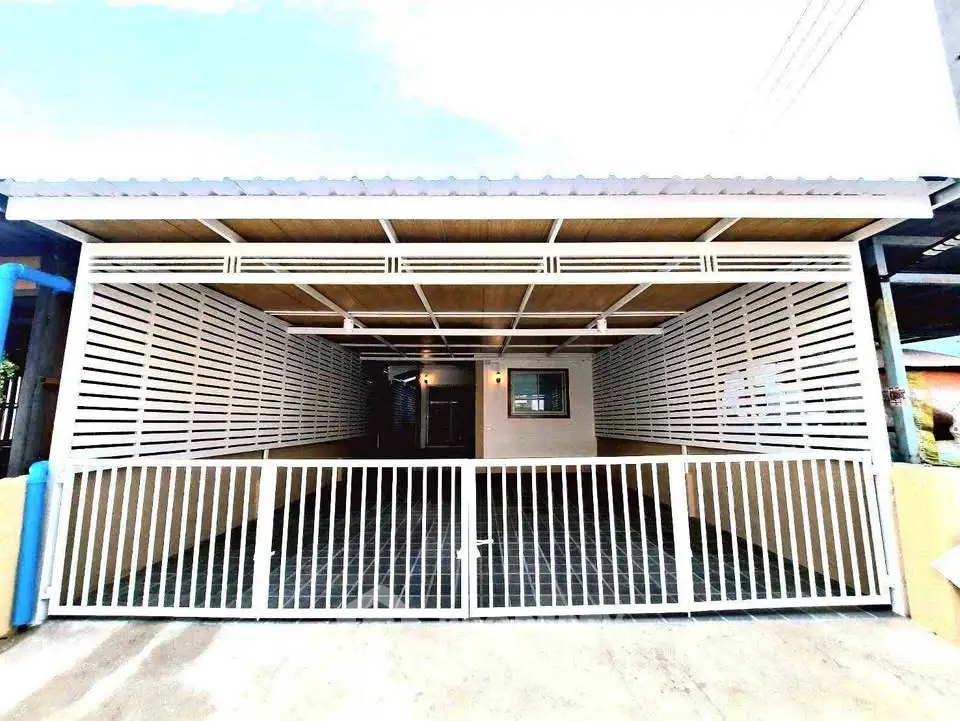 Modern single-story home with gated entrance and sleek exterior design.