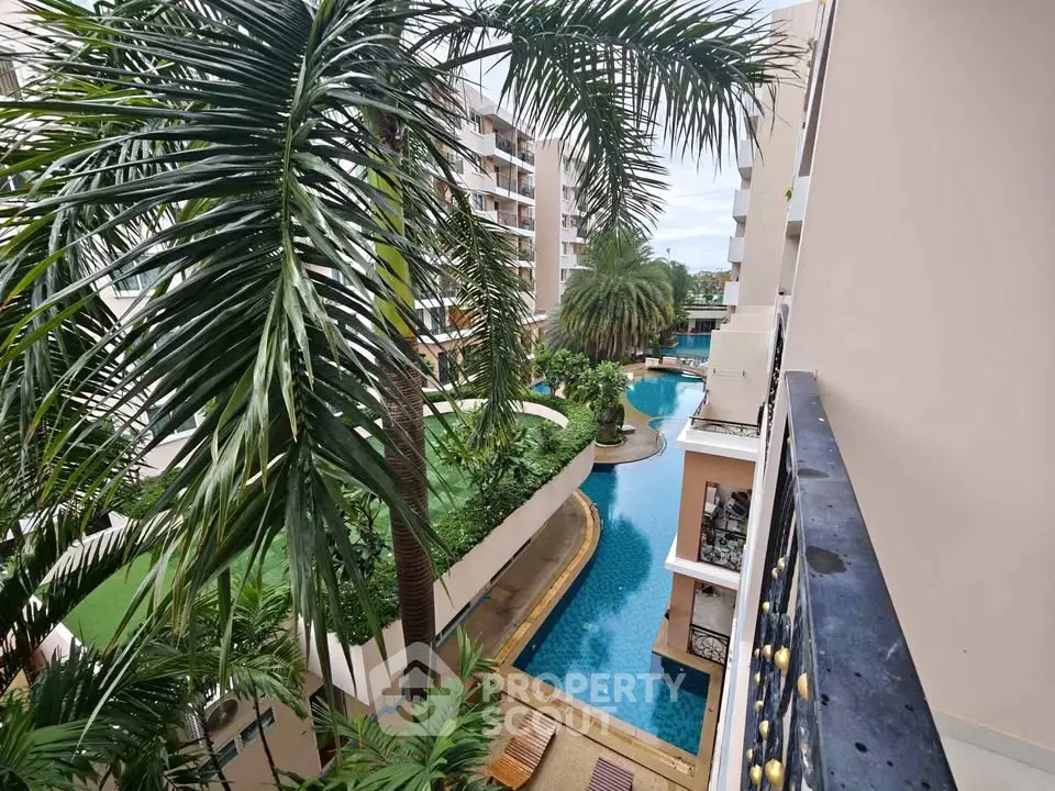 Luxurious apartment complex with stunning pool view and lush greenery.