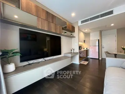 Modern living room with sleek TV unit and open kitchen layout