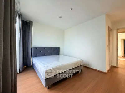 Spacious bedroom with modern design and natural light in a stylish apartment.