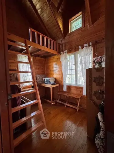 Charming wooden cabin interior with loft and natural light