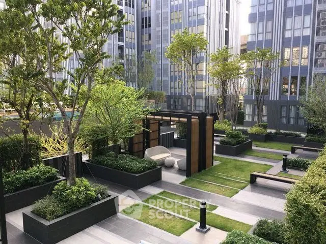 Luxurious urban garden with modern landscaping and seating area in high-rise complex.