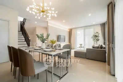 Luxurious open-plan living and dining area with modern decor and elegant lighting.