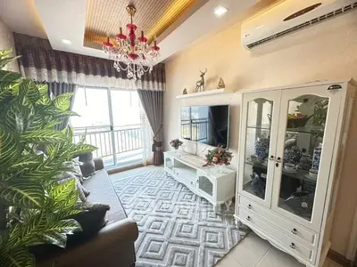 Elegant living room with plush seating, ornate chandelier, and a large window allowing ample natural light, perfect for sophisticated urban living.