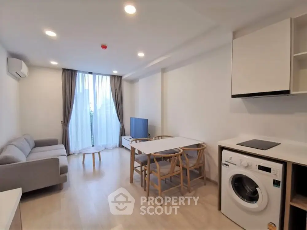 Modern studio apartment with integrated living space, featuring sleek furnishings, a fully equipped kitchenette, and a bright, airy ambiance perfect for urban living.
