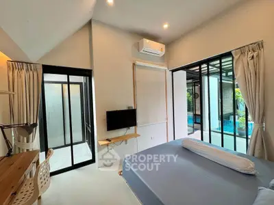 Modern bedroom with pool view and sleek interior design