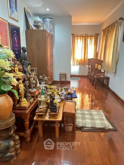 Serene living room with polished wooden floors and a dedicated meditation area.