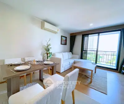 Spacious modern living room with dining area and balcony view in a stylish apartment.