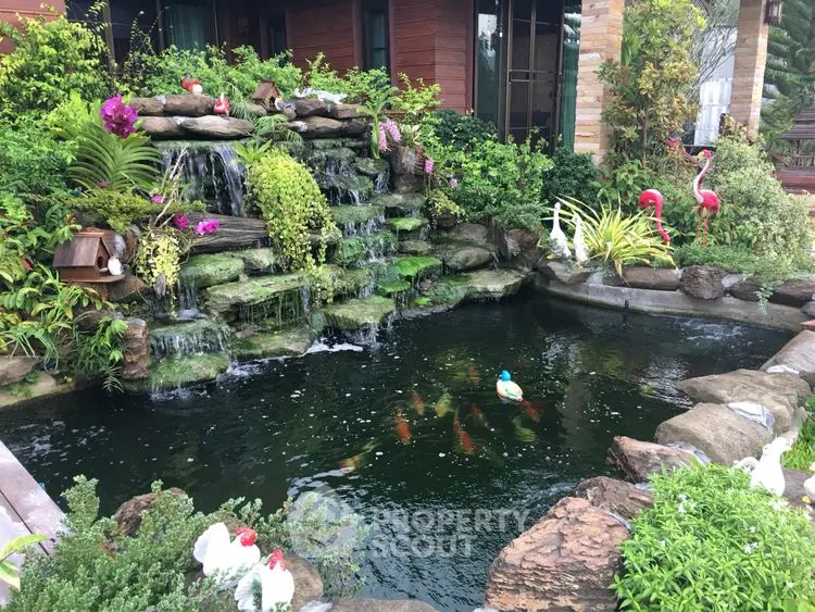 Stunning garden with waterfall and koi pond, perfect for serene outdoor living.