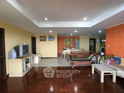 Spacious living room with wooden flooring and cozy seating area