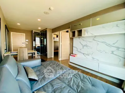 Modern living room with stylish furniture and marble accent wall