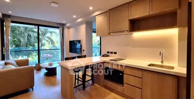 Modern open-layout kitchen and living room with garden view