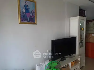 Cozy living room with TV and elegant wall art, perfect for relaxation.