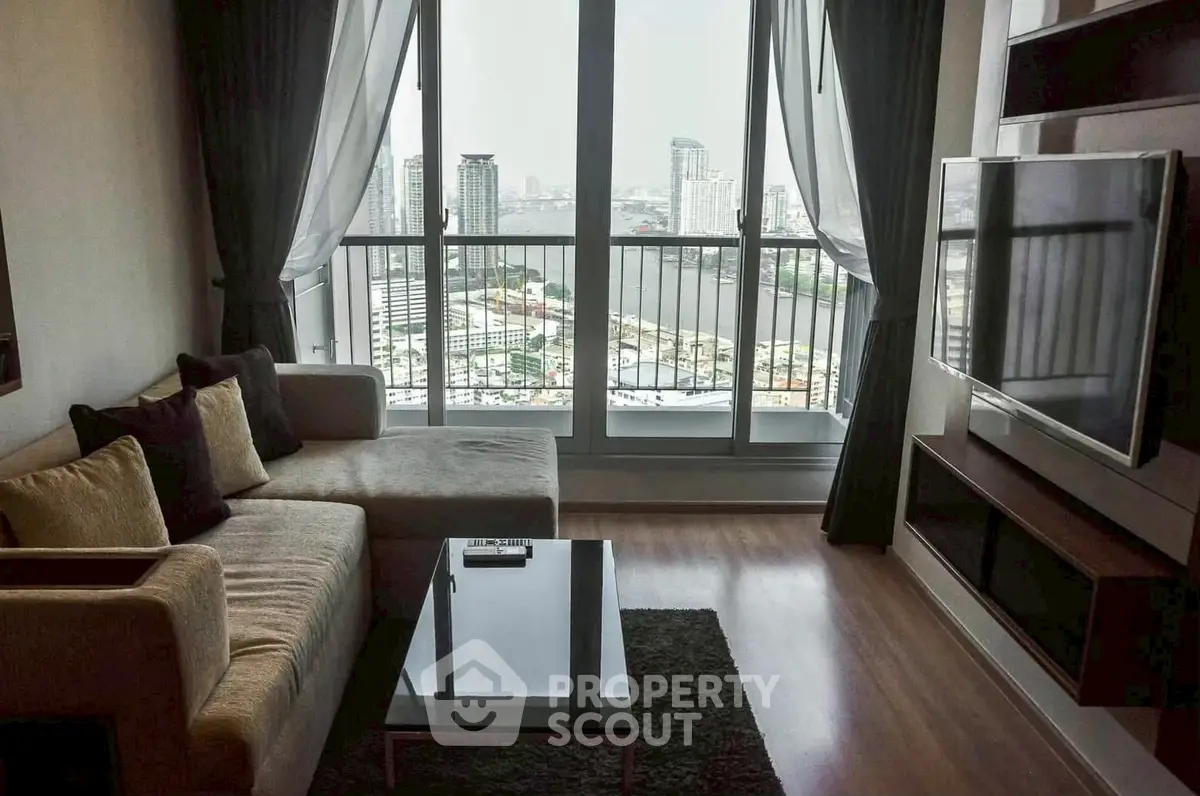 Modern living room with city view, featuring a cozy sofa and large TV, perfect for relaxation.
